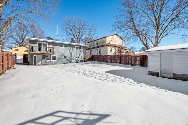 snow covered property with a wooden deck