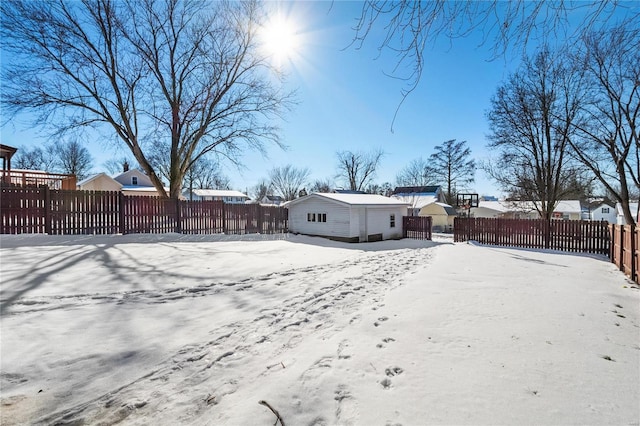 yard covered in snow featuring an outbuilding