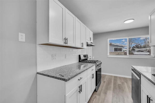 kitchen with decorative backsplash, white cabinetry, light stone countertops, and appliances with stainless steel finishes