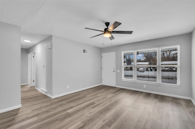 unfurnished room featuring light wood-type flooring and ceiling fan