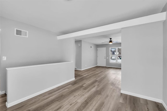 unfurnished room featuring hardwood / wood-style flooring and ceiling fan