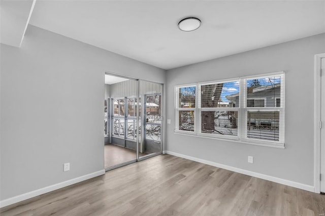 empty room featuring light hardwood / wood-style floors and a healthy amount of sunlight