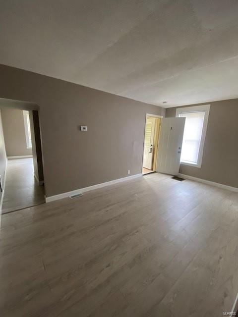 unfurnished room featuring wood-type flooring