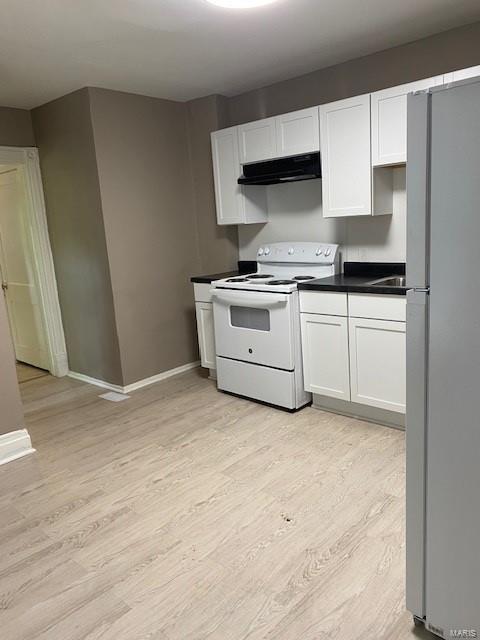 kitchen with sink, ventilation hood, light hardwood / wood-style floors, white appliances, and white cabinets