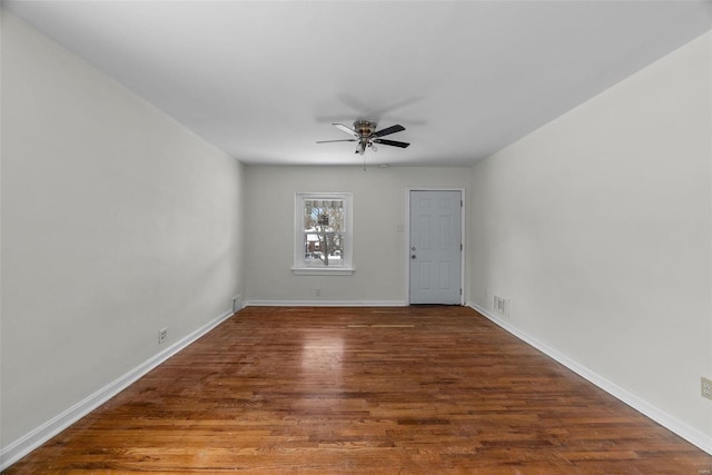 empty room with hardwood / wood-style floors and ceiling fan