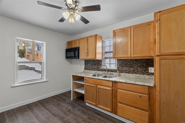 kitchen featuring ceiling fan, dark hardwood / wood-style flooring, sink, and a wealth of natural light