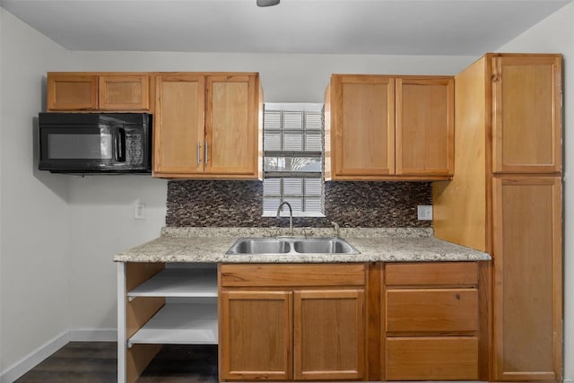 kitchen with backsplash, sink, and dark wood-type flooring