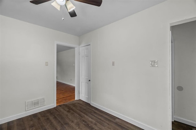 spare room featuring ceiling fan and dark hardwood / wood-style floors