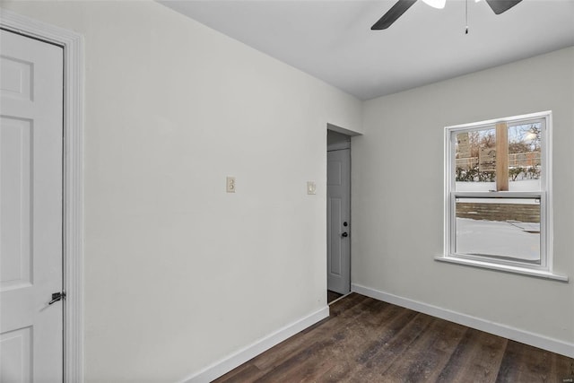 spare room featuring ceiling fan and dark wood-type flooring