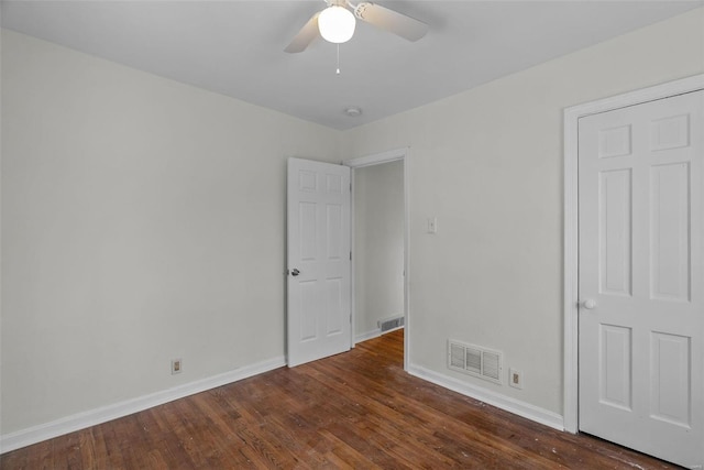 spare room featuring dark hardwood / wood-style floors and ceiling fan