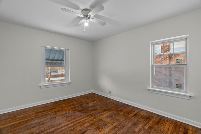 empty room featuring ceiling fan and dark wood-type flooring