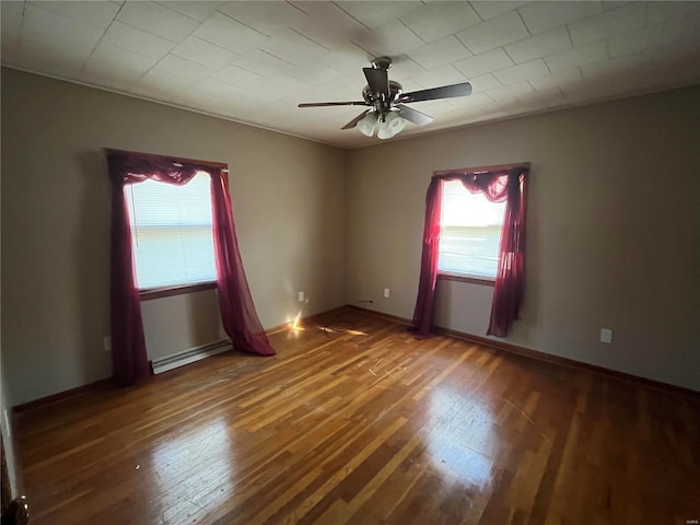 spare room featuring a baseboard radiator, ceiling fan, and dark wood-type flooring