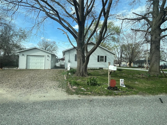 view of front of house with a garage and an outdoor structure