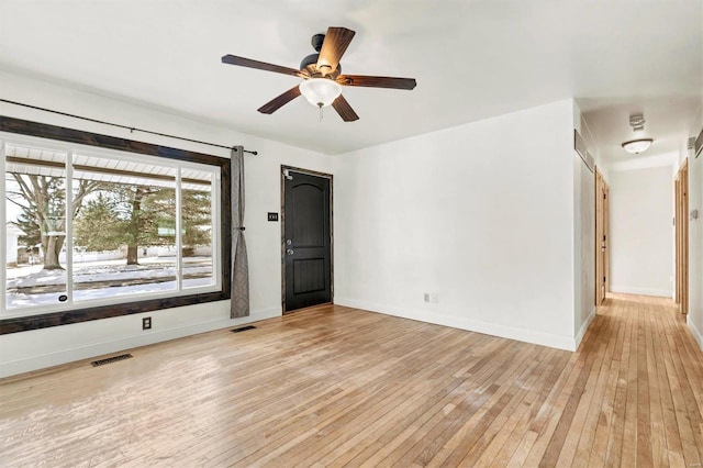 spare room featuring ceiling fan and light wood-type flooring