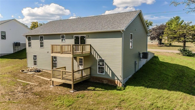 rear view of property with a wooden deck and a yard