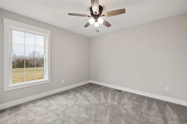 carpeted spare room with ceiling fan