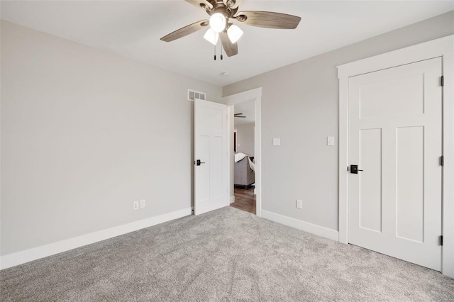 unfurnished bedroom with light carpet and ceiling fan