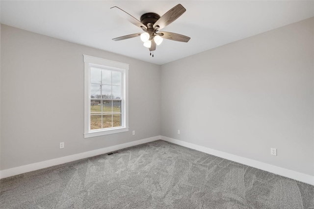 spare room with carpet and ceiling fan