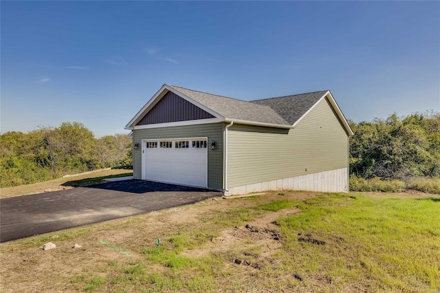 view of property exterior featuring a yard and a garage