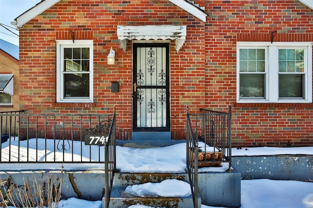 view of snow covered property entrance