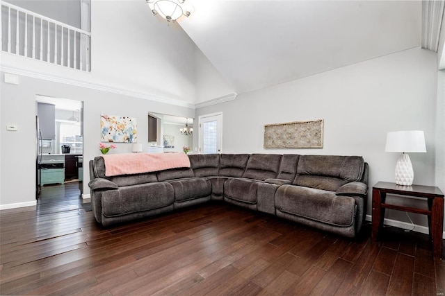 living room with high vaulted ceiling, a chandelier, and dark hardwood / wood-style flooring