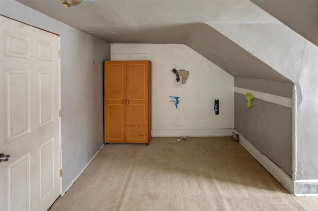 additional living space with light carpet and lofted ceiling