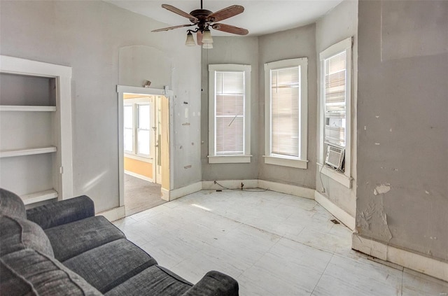 living room featuring ceiling fan, plenty of natural light, and cooling unit