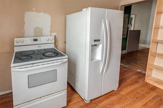 kitchen featuring light wood-type flooring and white appliances