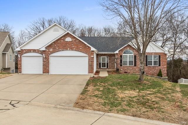 ranch-style house featuring a front yard and a garage