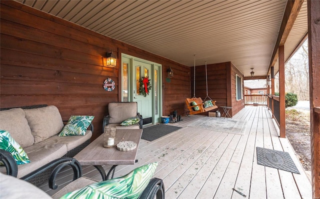 wooden deck featuring outdoor lounge area and covered porch