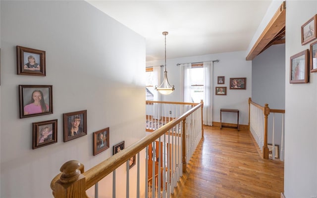 hallway with light hardwood / wood-style floors