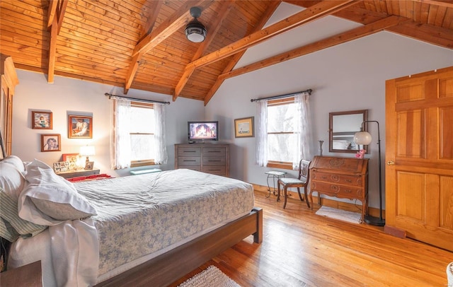 bedroom with vaulted ceiling with beams, ceiling fan, light hardwood / wood-style flooring, and multiple windows