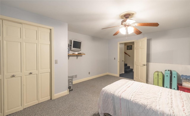 carpeted bedroom featuring ceiling fan and a closet