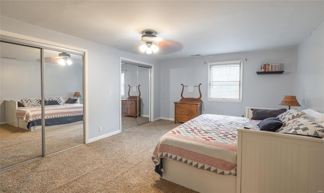 bedroom featuring carpet, two closets, and ceiling fan