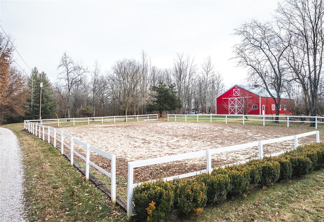 view of yard with a rural view and an outdoor structure