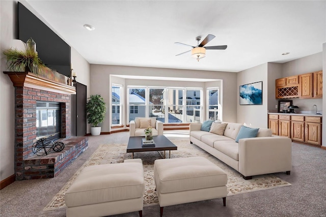 living room with ceiling fan, light carpet, a fireplace, and wet bar