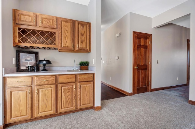 bar featuring sink and carpet