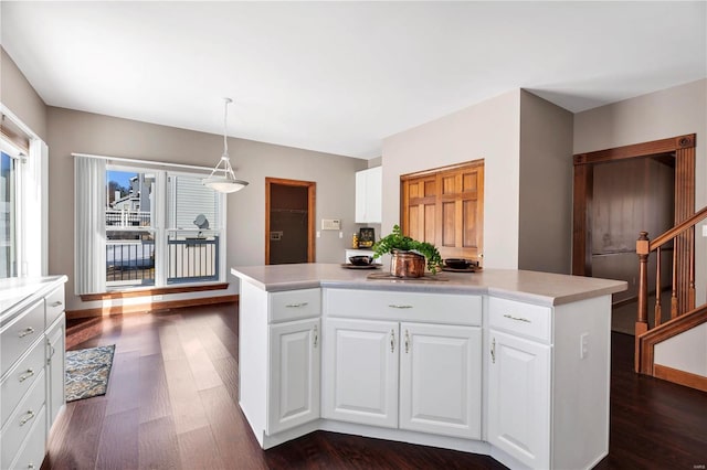 kitchen featuring a kitchen island, white cabinets, and hanging light fixtures