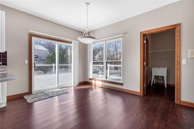 unfurnished dining area featuring dark hardwood / wood-style flooring