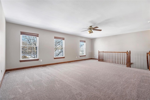 unfurnished room featuring ceiling fan and carpet flooring