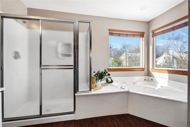 bathroom featuring wood-type flooring and independent shower and bath