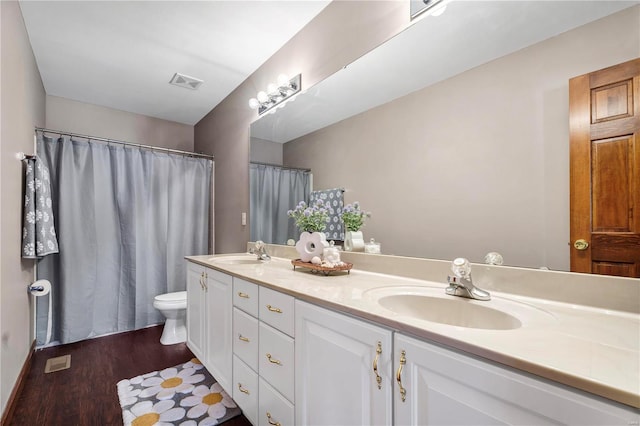 bathroom featuring toilet, hardwood / wood-style floors, and vanity