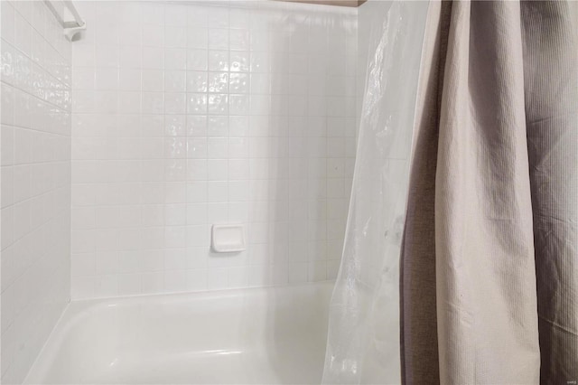 room details featuring shower / bath combination with curtain