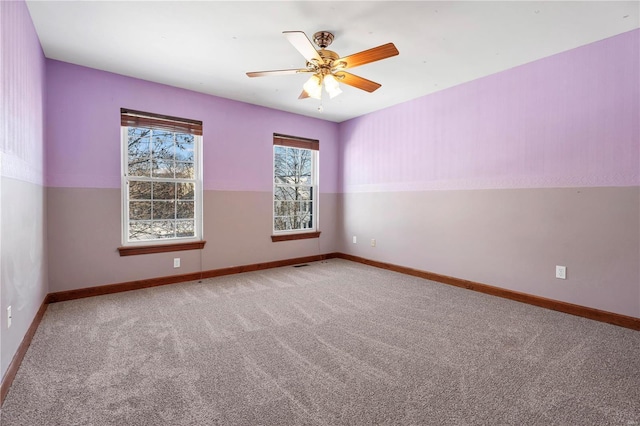 empty room featuring ceiling fan and light colored carpet