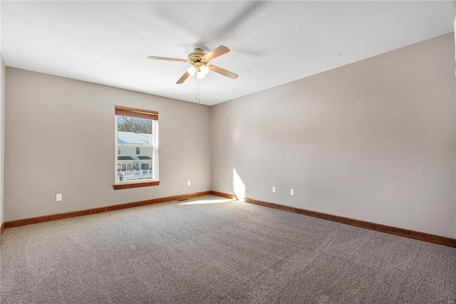 spare room featuring ceiling fan and carpet