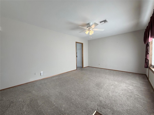 spare room with carpet floors and ceiling fan