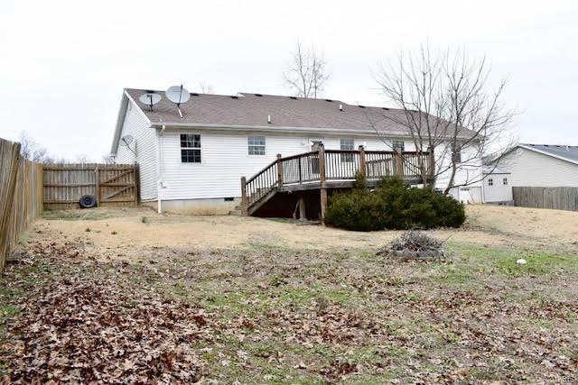 rear view of property with a wooden deck