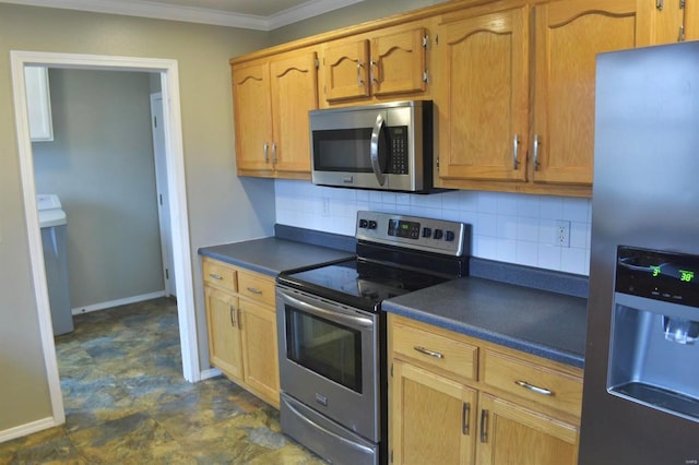 kitchen with decorative backsplash, washer / dryer, crown molding, and appliances with stainless steel finishes