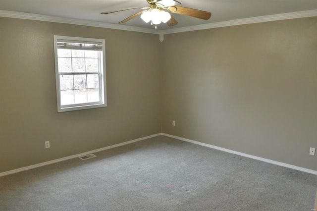 spare room featuring ceiling fan, crown molding, and carpet floors