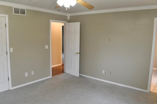 unfurnished bedroom with ceiling fan, crown molding, and light carpet